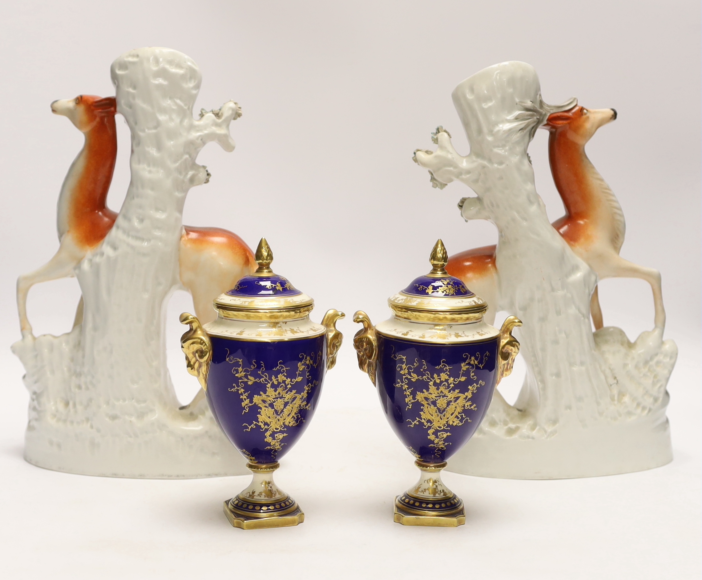 A pair of Coalport vases and covers and a pair of Staffordshire deer spill vases, largest 29cm high